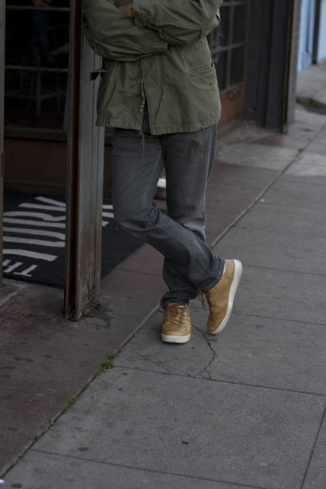 military jacket and tan sneakers
