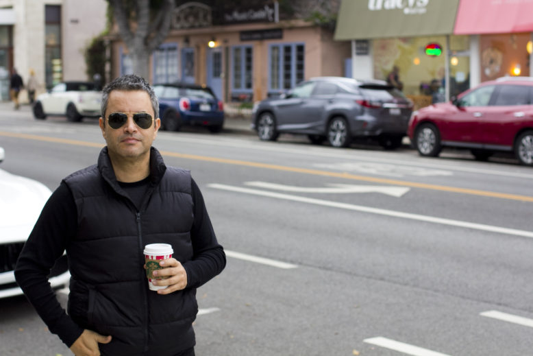 Taking a walk in Santa Monica in my black vest outfit with a cup of coffee